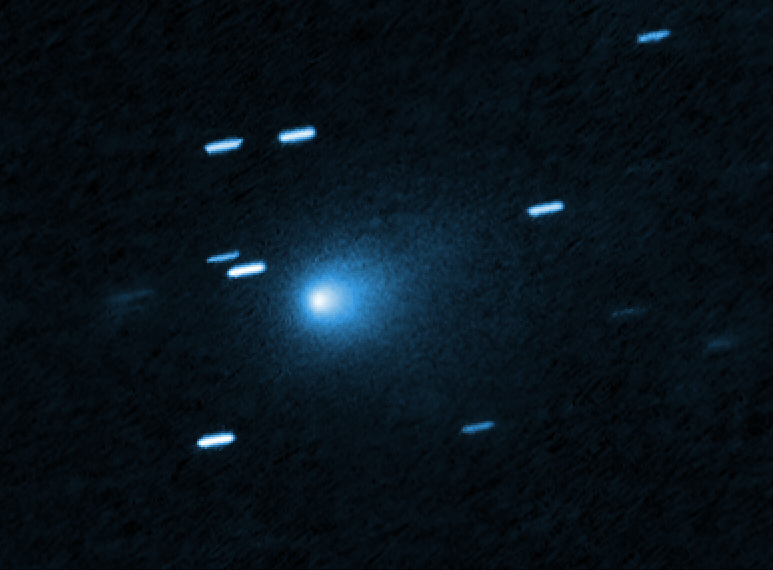 Hubble Space Telescope image of interstellar comet 3I/ATLAS showing a teardrop-shaped coma of dust around its icy nucleus