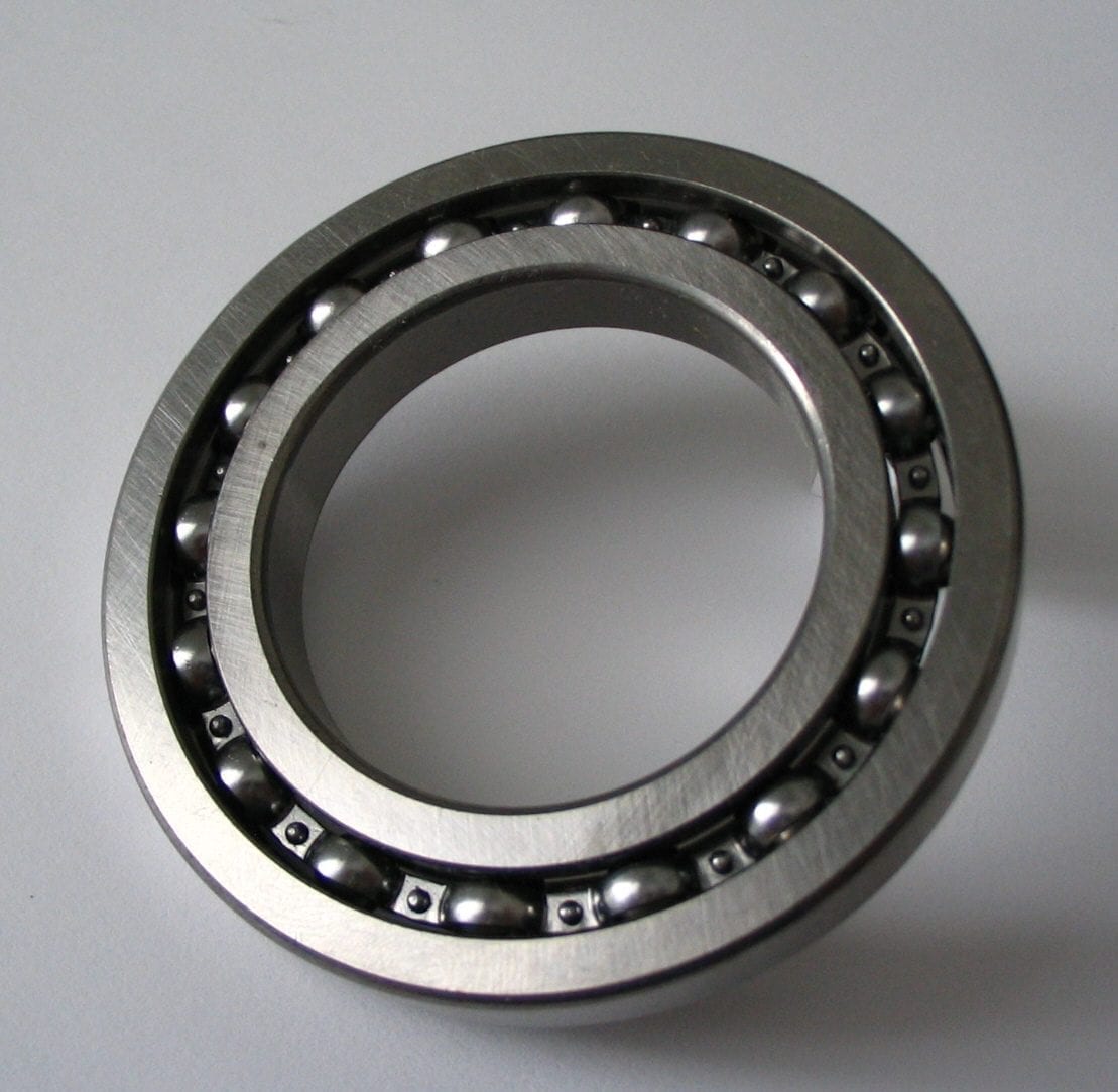 Close-up of a polished stainless steel ball bearing showing its spherical rolling elements set in the metal race.