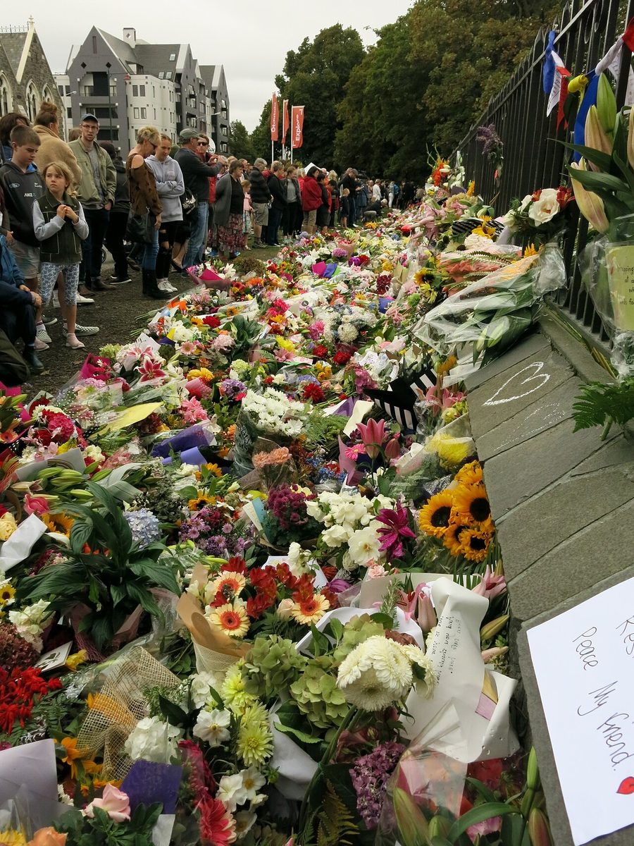Mourners and a vast bank of flowers and handwritten notes left as tributes to the victims of the Christchurch mosque shootings.