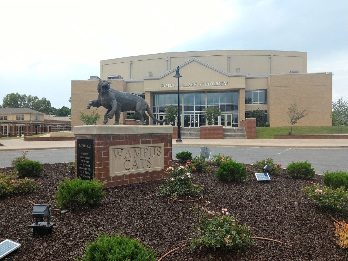 Bronze statue of a six-legged mountain-lion-like Wampus Cat mascot outside a building in Conway, Arkansas